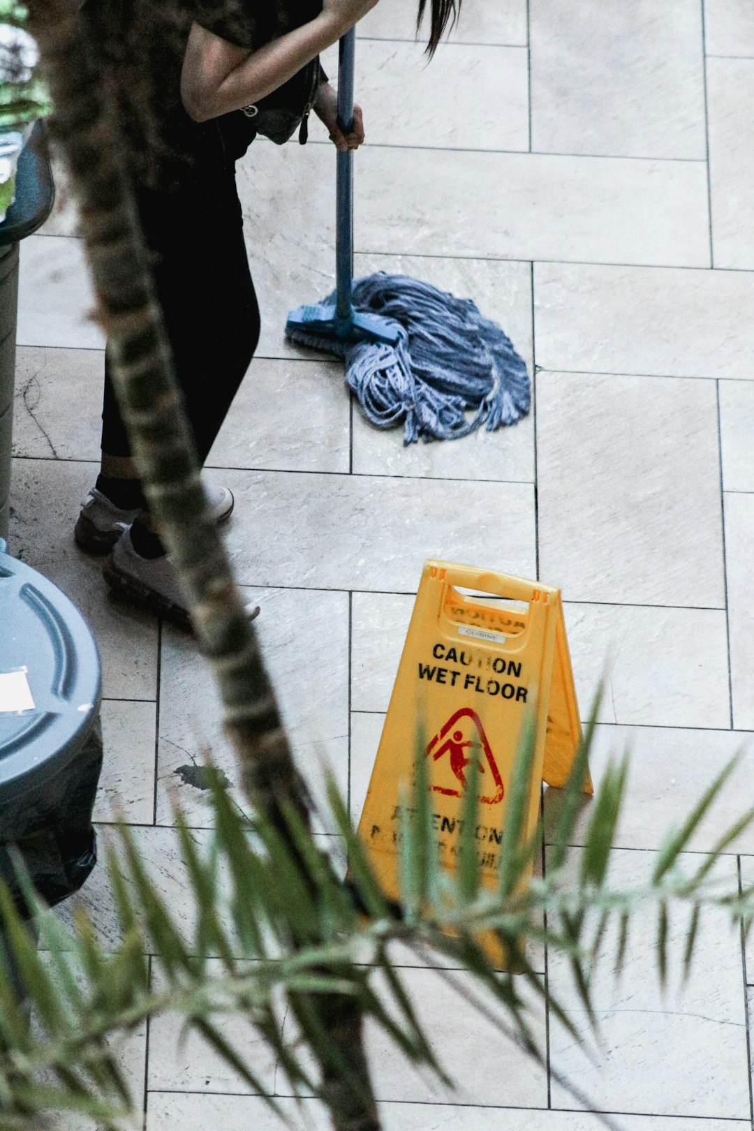 about-01 a-woman-sweeping-the-floor-with-a-mop-lmjpx-mv7hq